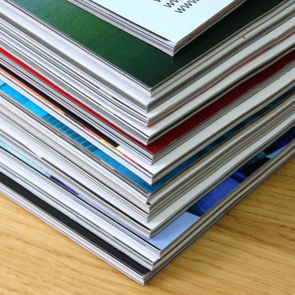 Pile of magazines on a wooden background